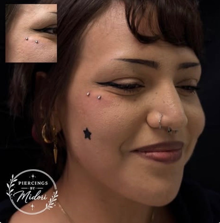 Anti-eyebrow surface bar piercing after placement