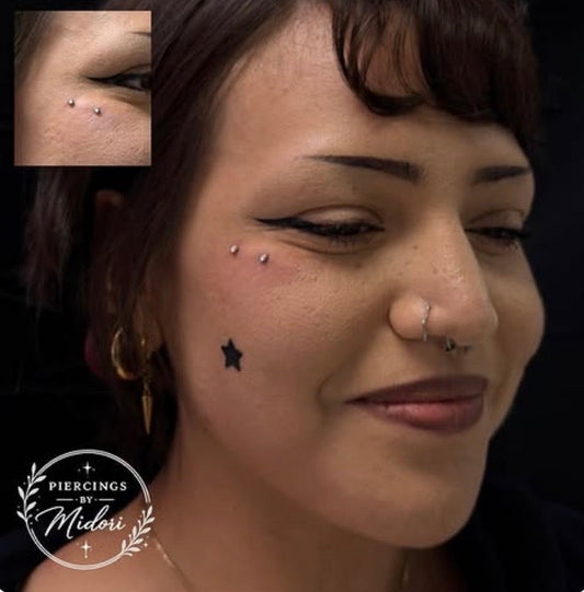 Anti-eyebrow surface bar piercing after placement
