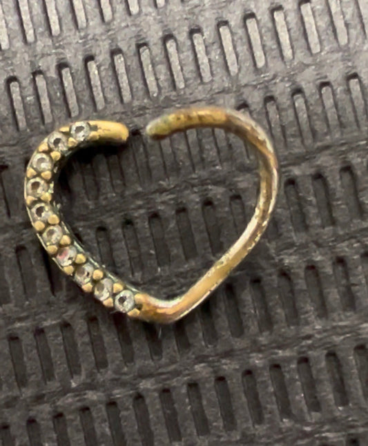 cheap body jewelry showing its wear
