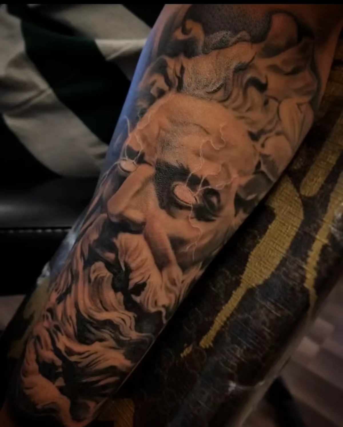 Photo realistic Zeus arm sleeve tattoo